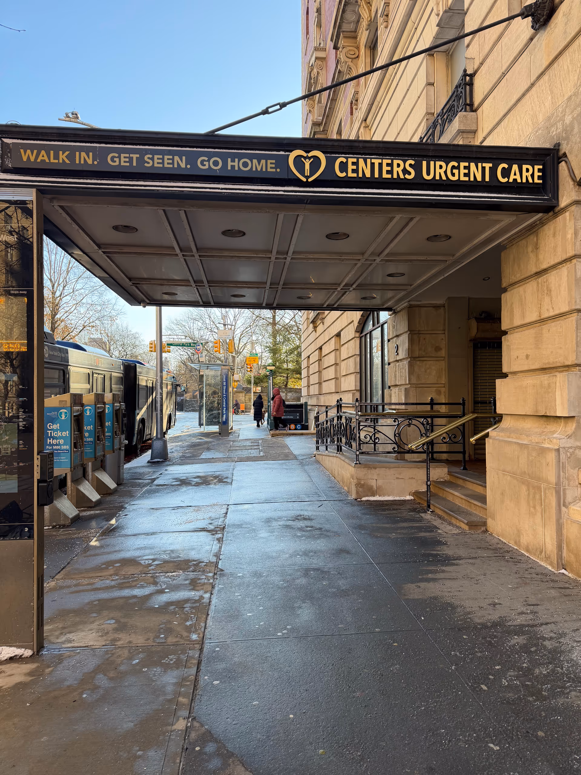 Sidewalk view of the Centers Urgent Care entrance with a covered awning.