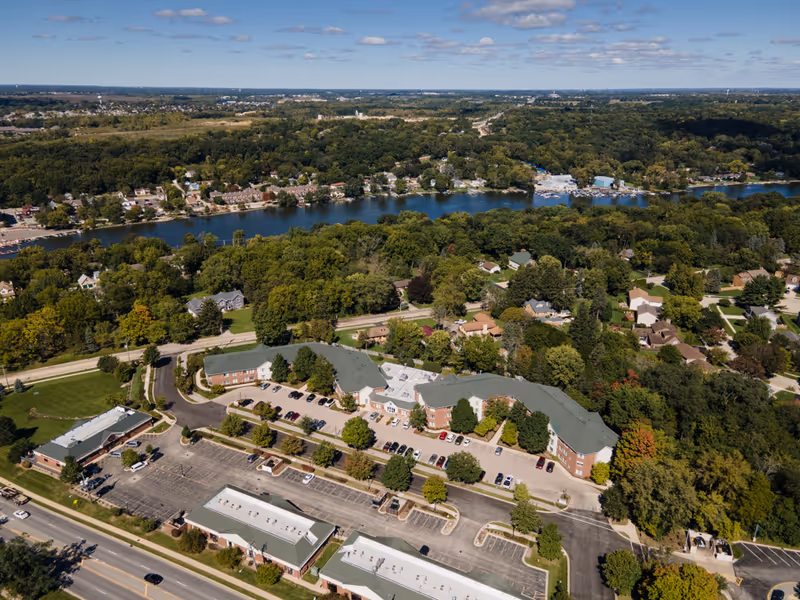 Aerial view of The Pointe at Eastgate campus with multiple buildings and parking near a river.