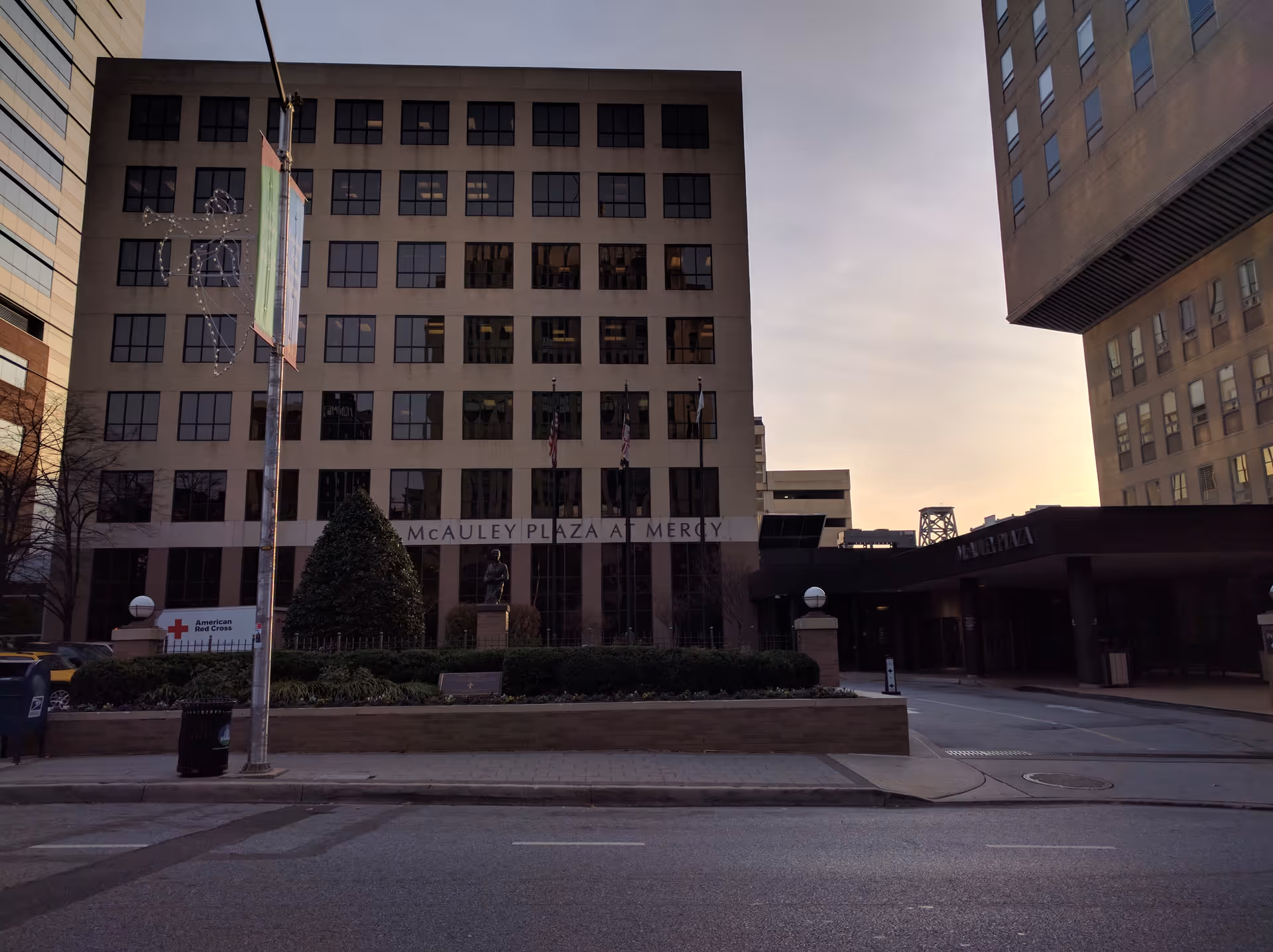 Exterior view of Mercy Medical Center with plaza, statue, and entry canopy.