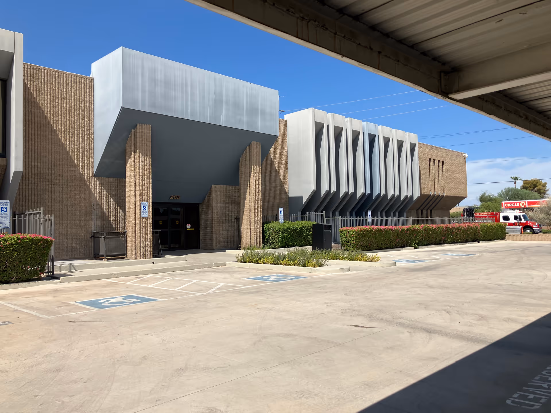 Exterior view of Prileo Home Care building with entrance, parking, and hedges.