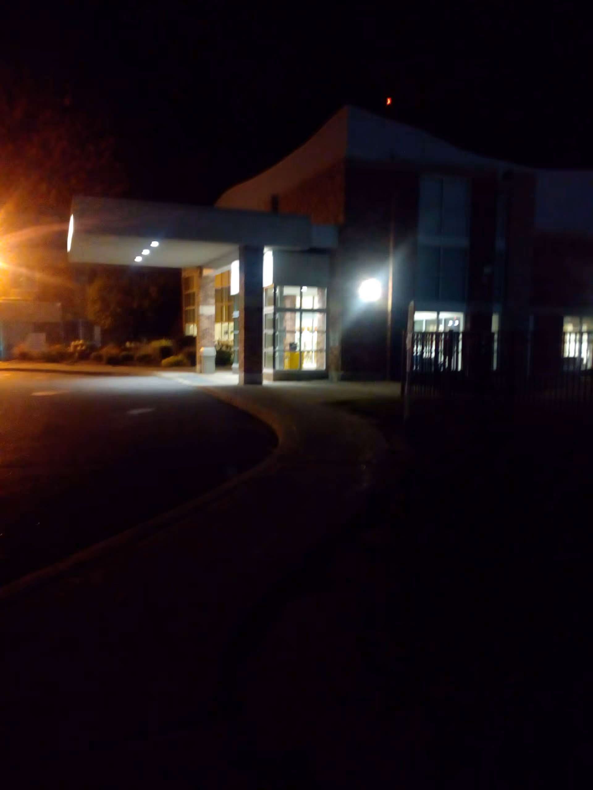 Night exterior of RRH Newark-Wayne entrance with illuminated glass doors