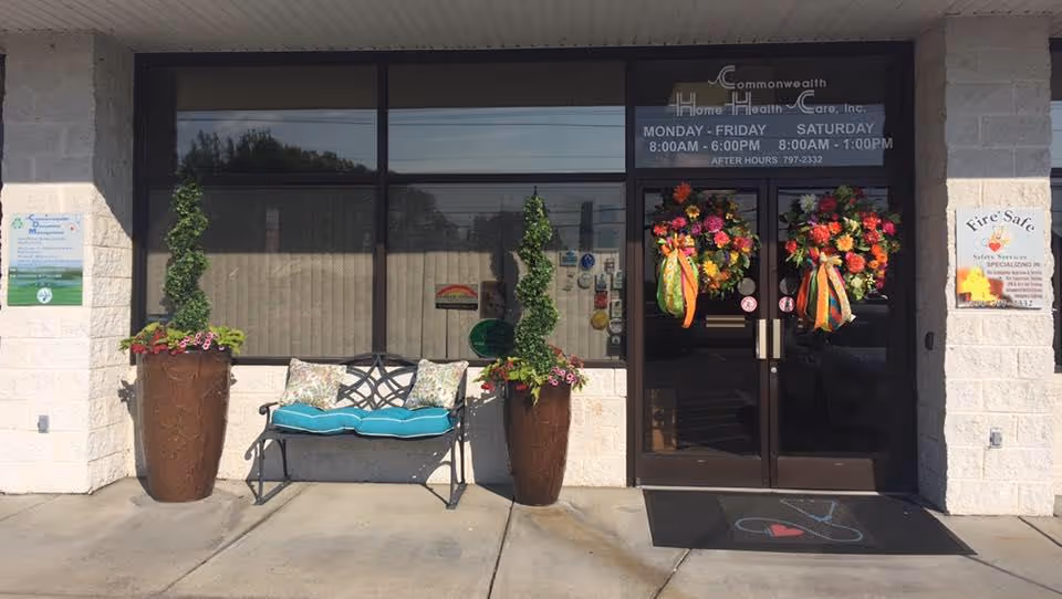 Entrance to Commonwealth Home Health Care with double doors, planters, and a bench.