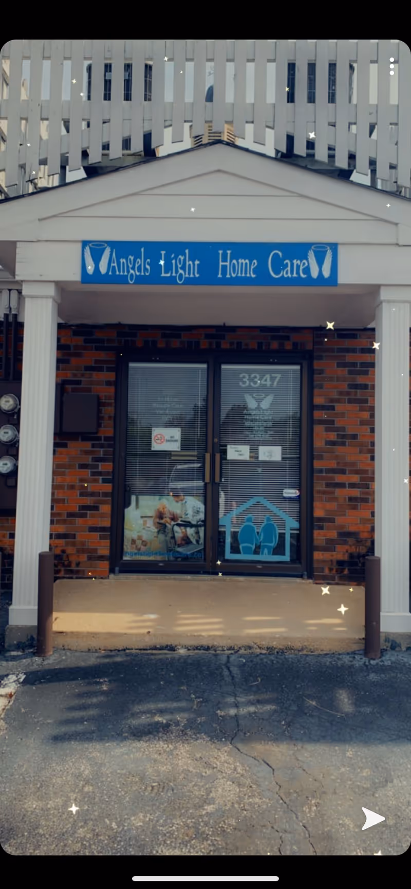 Brick building front with a blue Angels Light Home Care sign above glass doors.