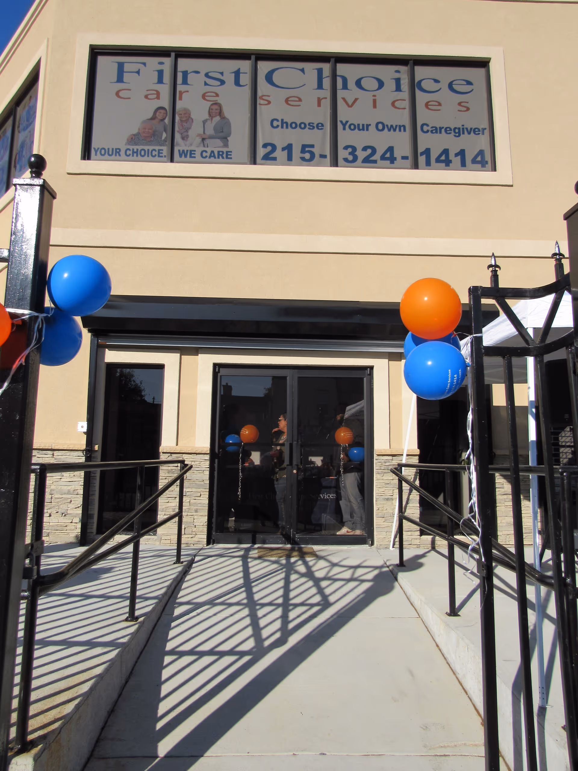 Front entrance of First Choice Care Services with blue and orange balloons.