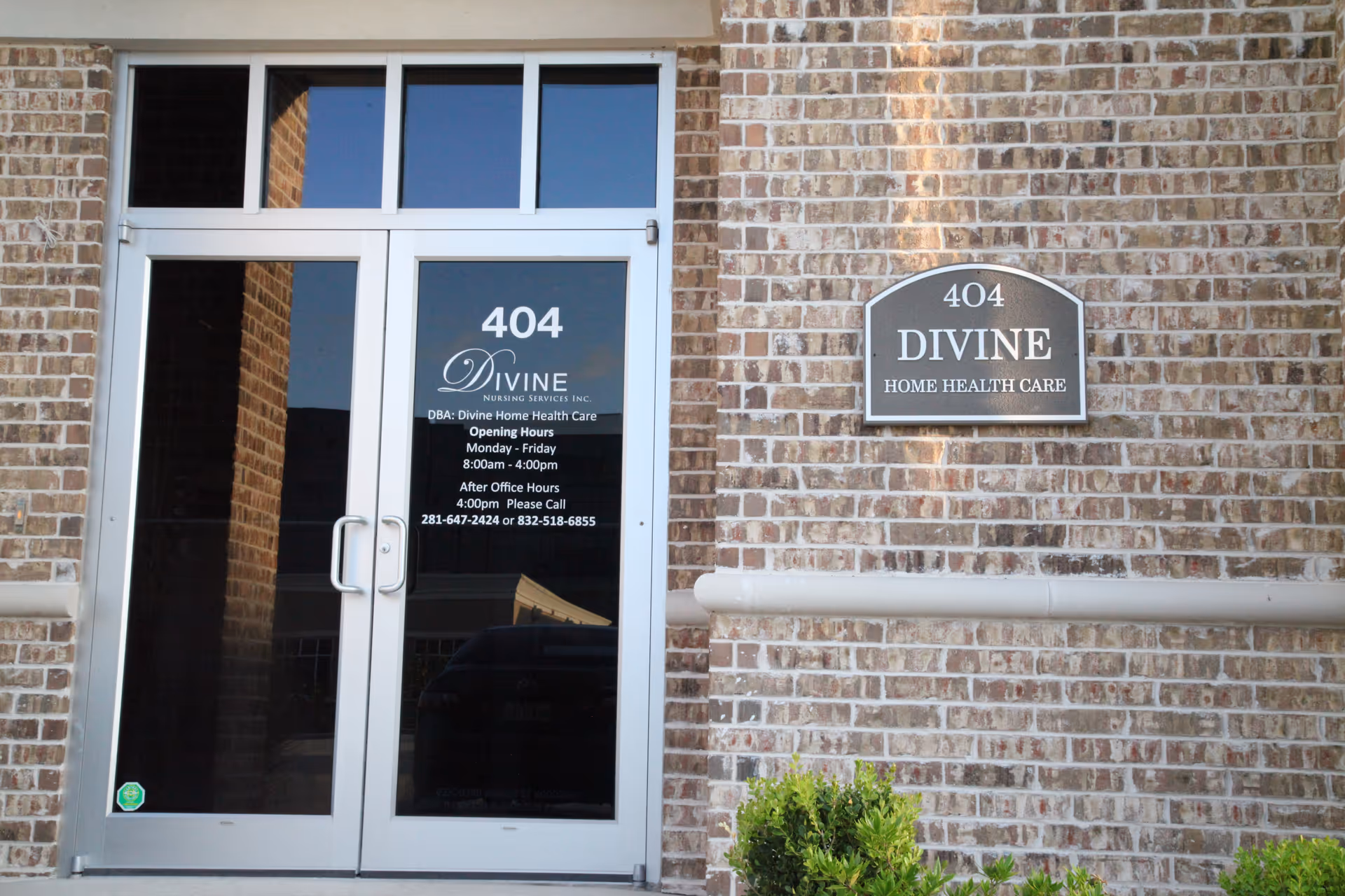 Brick building exterior with a glass door labeled 404 and Divine Home Health Care sign.