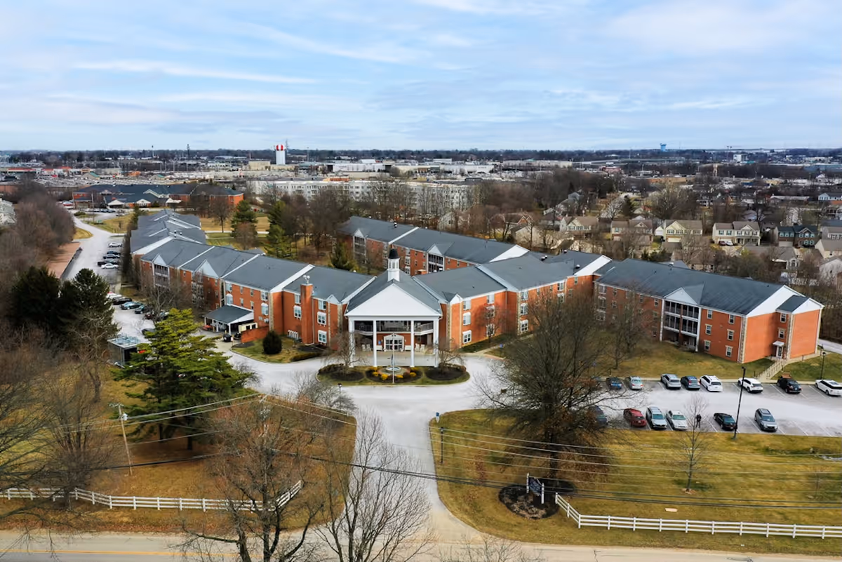 Aerial view of Colonial Heights Senior Living campus with brick buildings and parking.