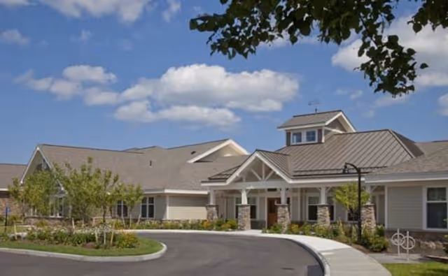 Exterior view of Bridges by EPOCH at Westford with curved driveway and landscaped entrance.