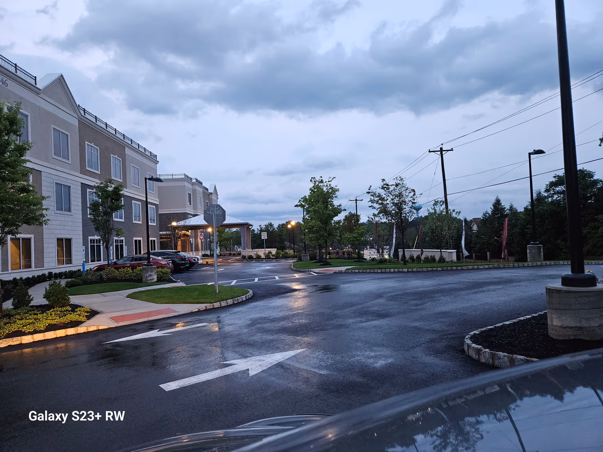 Exterior view of Spring Hills Livingston senior living with a parking lot and entrance canopy.