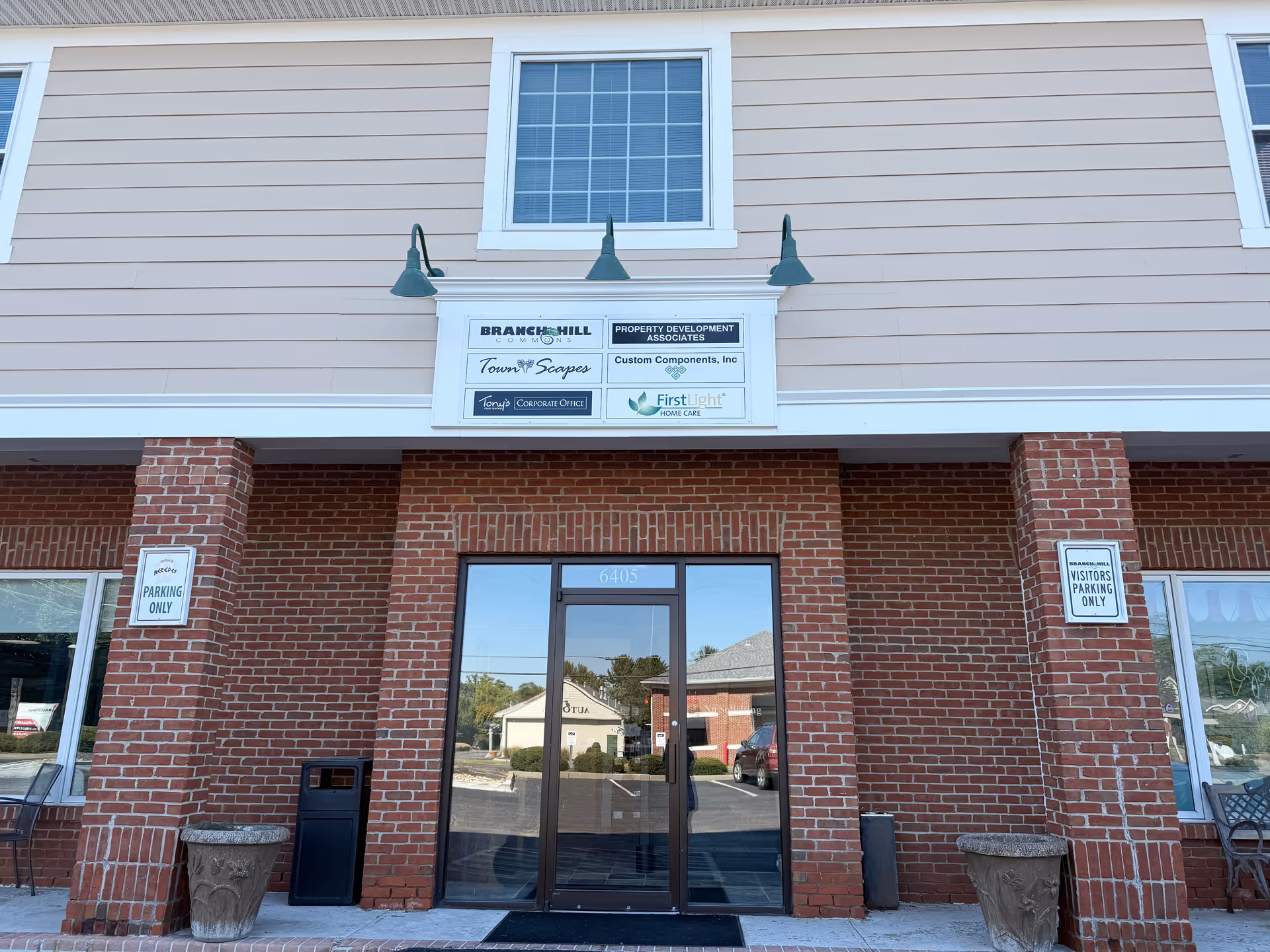 Exterior view of FirstLight Home Care Loveland entrance with brick facade and glass doors.