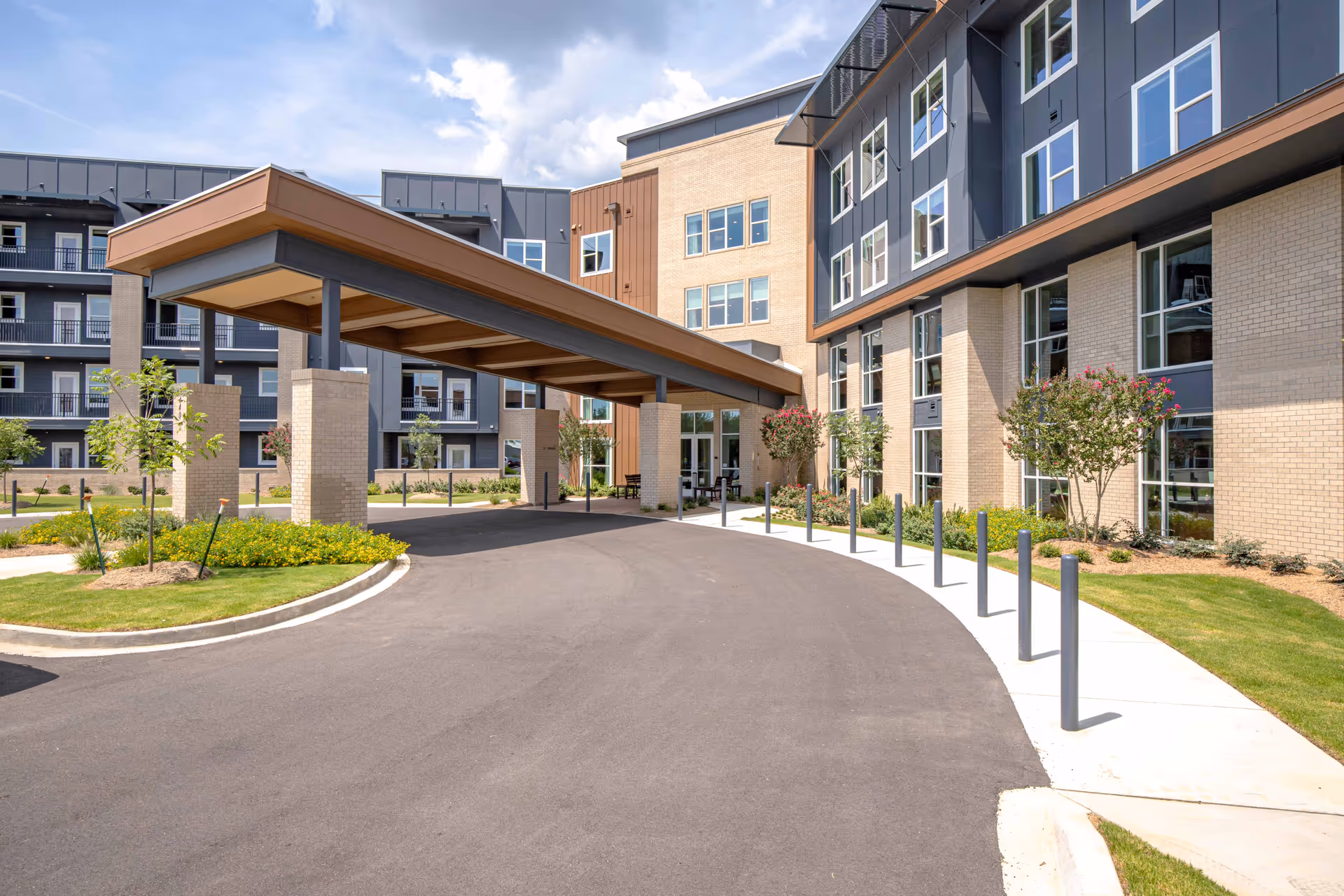 Exterior view of Inspire Sandhill with a covered entrance and landscaped driveway.