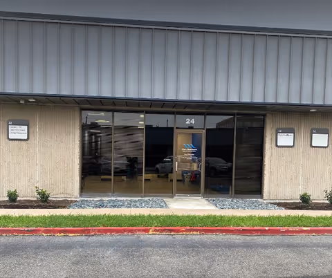 Exterior view of Wave Healthcare Corpus Christi entrance with glass doors and parking