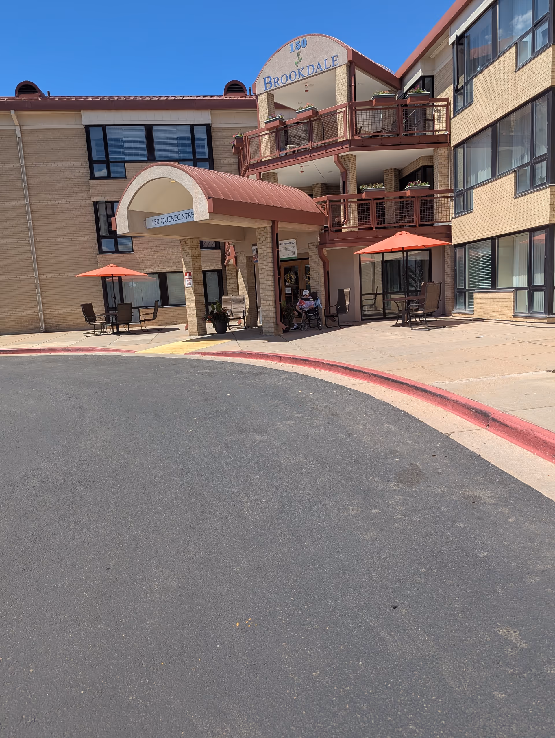 Exterior view of Brookdale Lowry with front entrance canopy and outdoor seating.