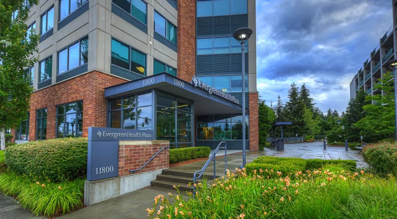 Exterior entrance of EvergreenHealth facility with brick facade and landscaped approach.