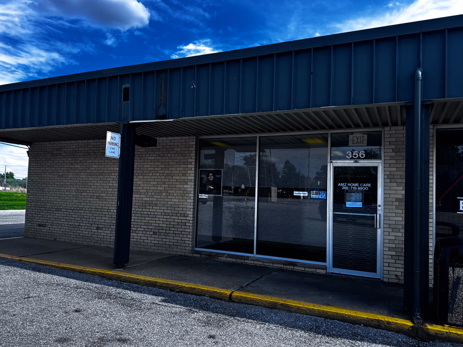 Exterior view of AMZ Home Care storefront with glass doors and brick walls.