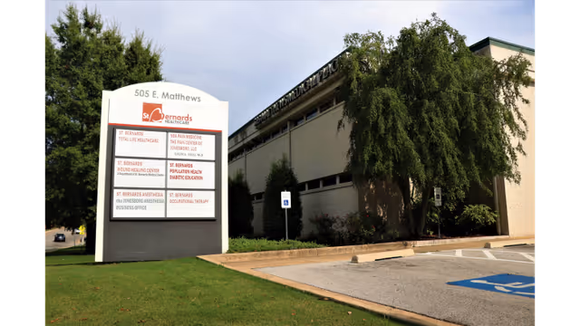 Exterior view of St. Bernards Total Life Healthcare building with a large sign and parking lot.