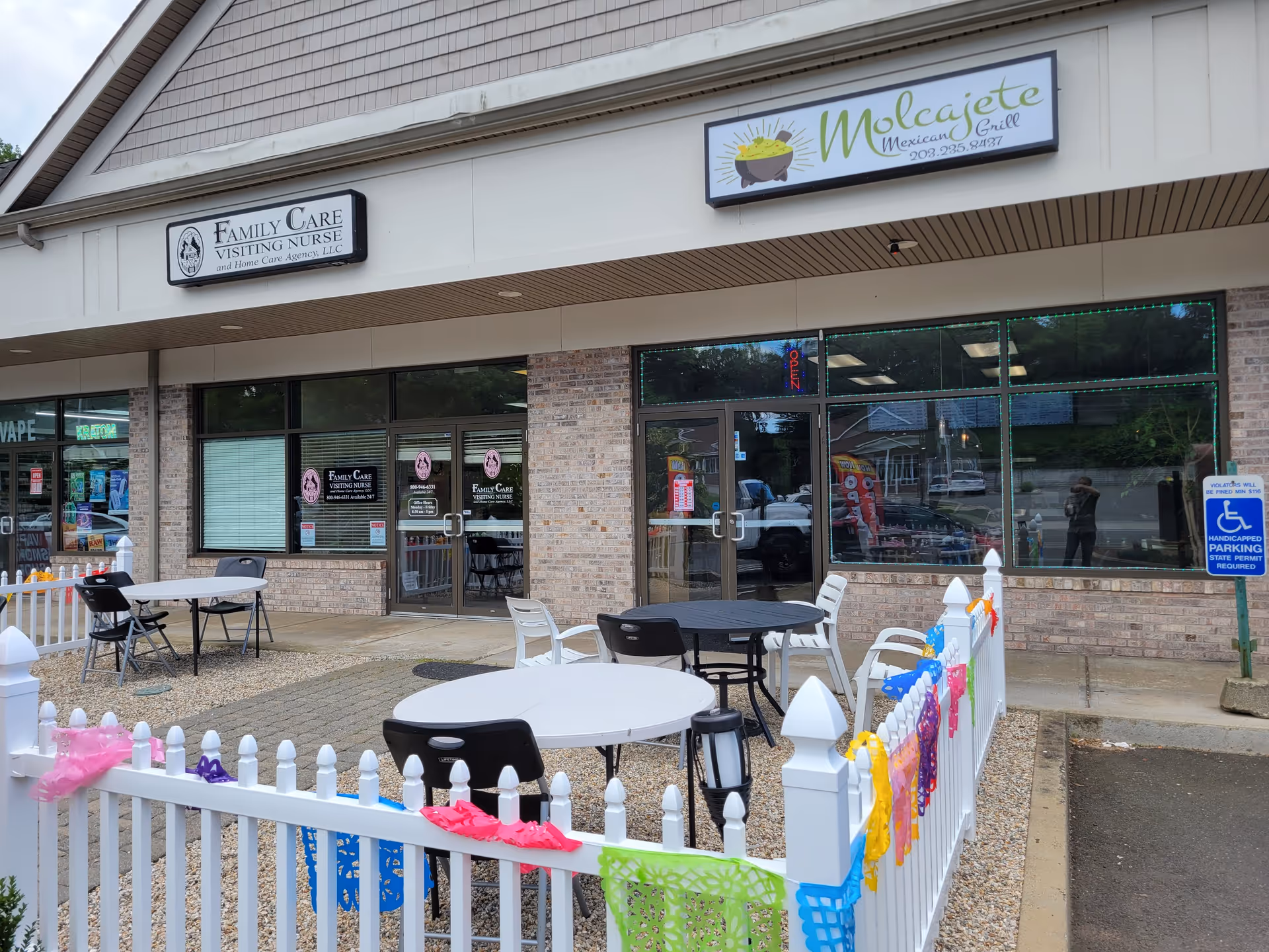 Exterior view of Family Care Visiting Nurse storefront with outdoor seating and decorations.