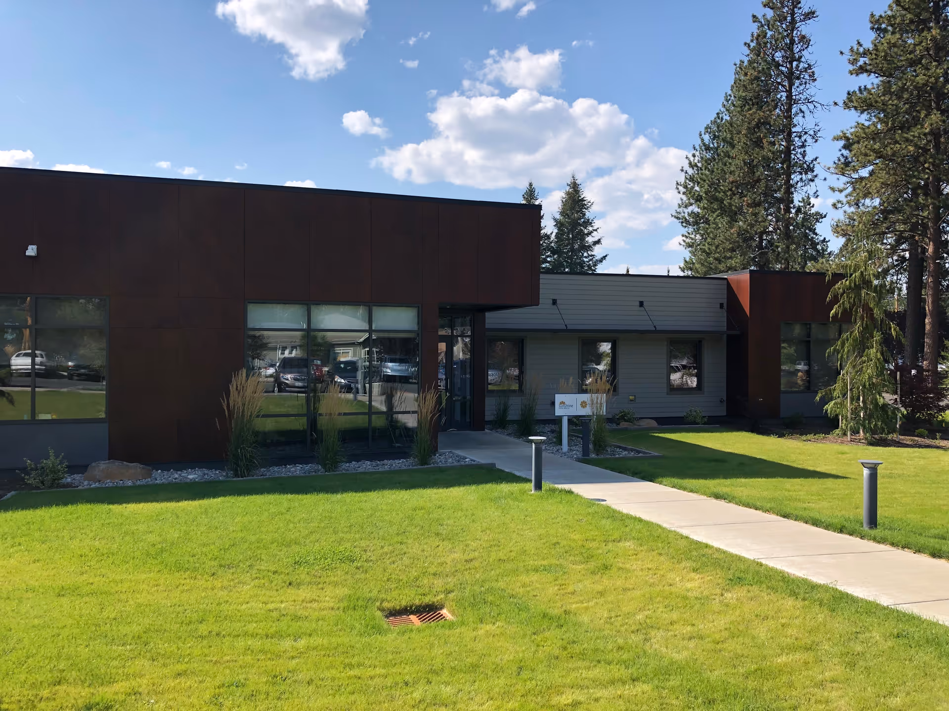Sunshine Home Health exterior: modern, single-story building with large windows and a walkway.