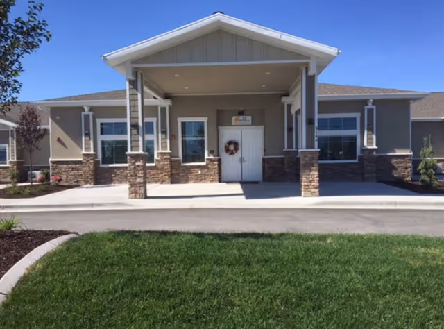 BeeHive Homes of Orem front entrance with covered portico and manicured lawn