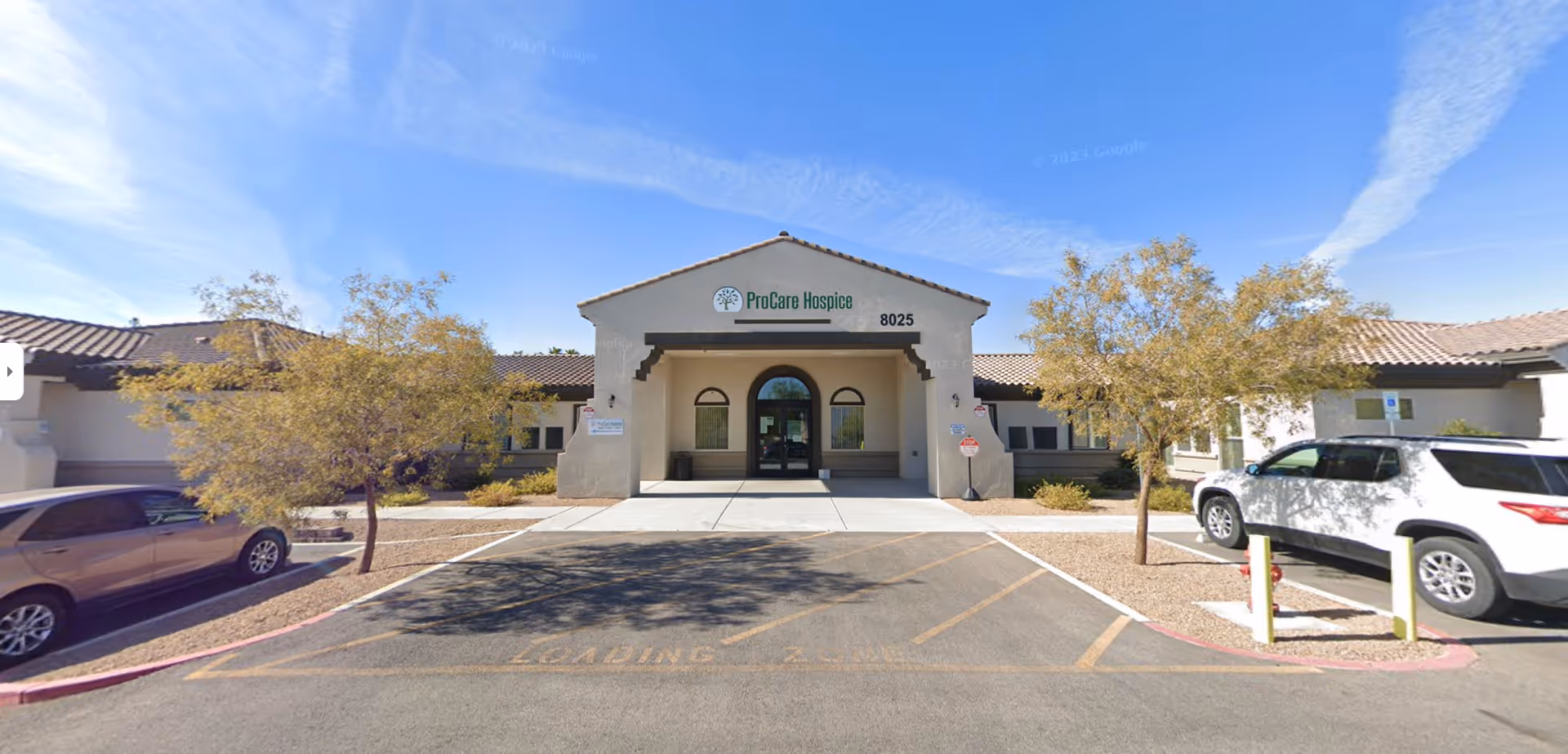 Front view of ProCare Hospice of Nevada building with parking and desert landscaping.