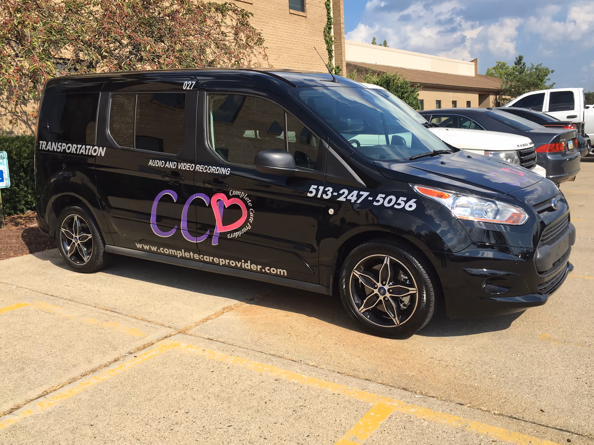 Black Complete Care Providers transportation van with logo parked in a lot.