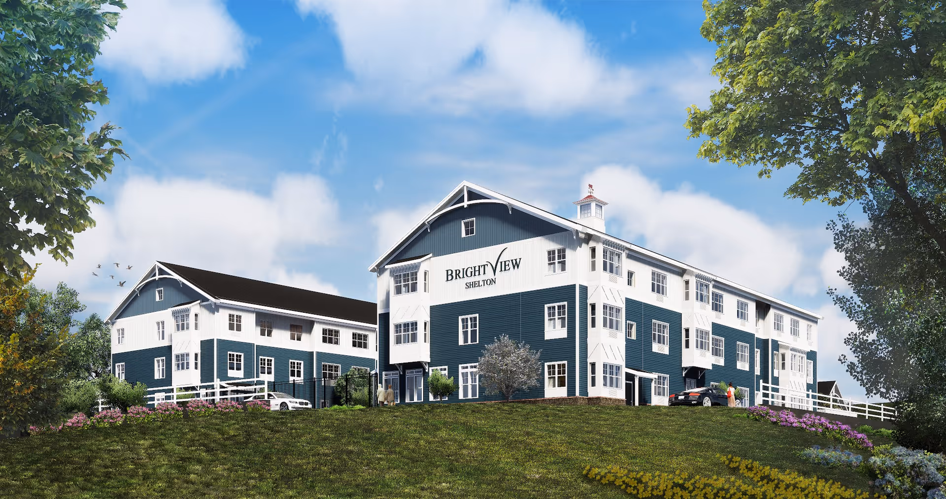 Three-story blue-and-white senior living building labeled "Brightview Shelton" on a grassy hill under a blue sky.
