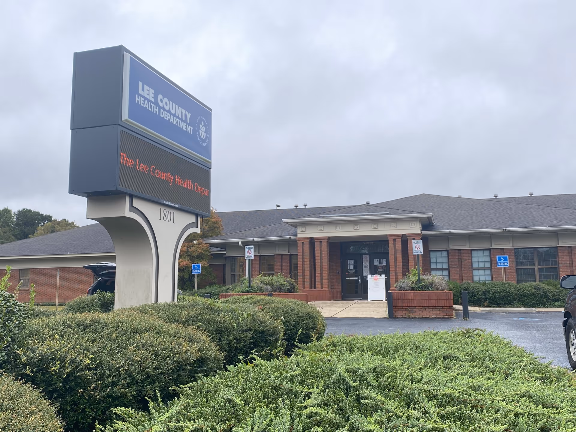 Exterior view of a brick building with a Lee County Health Department sign.