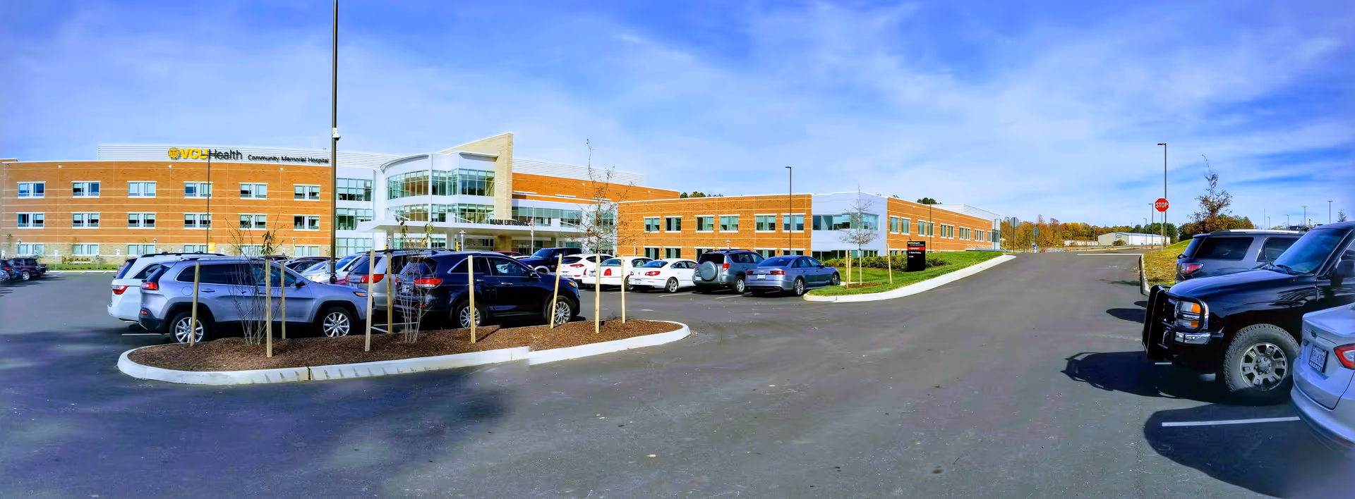 Wide exterior view of VCU Health Community Memorial Hospital with a parking lot.