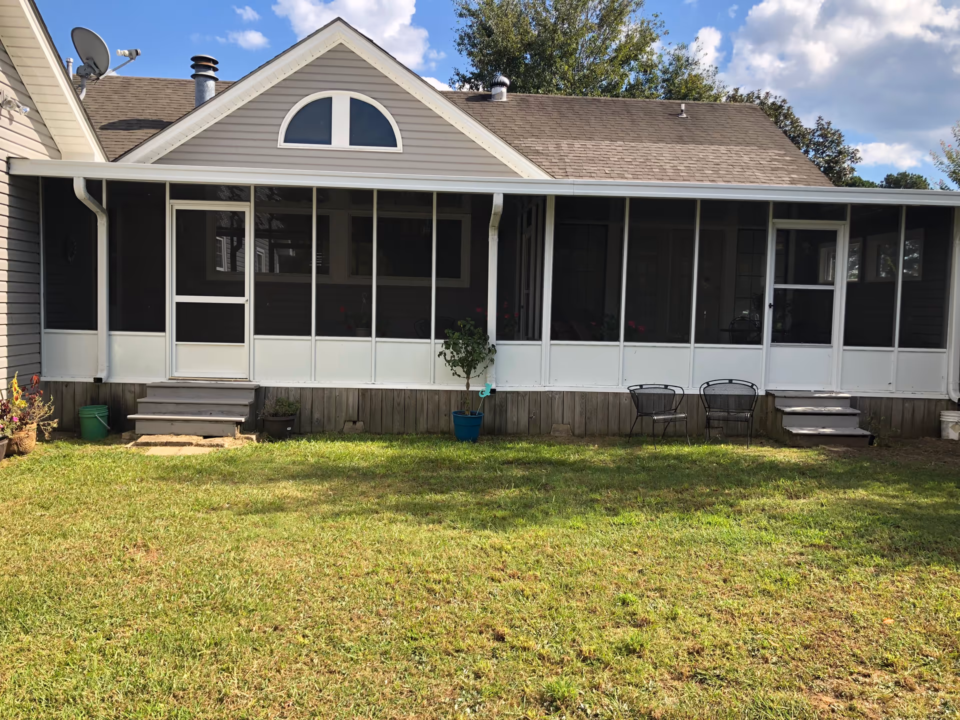 Front view of Pleasant Hill Care Homes building with screened porch and grassy yard.