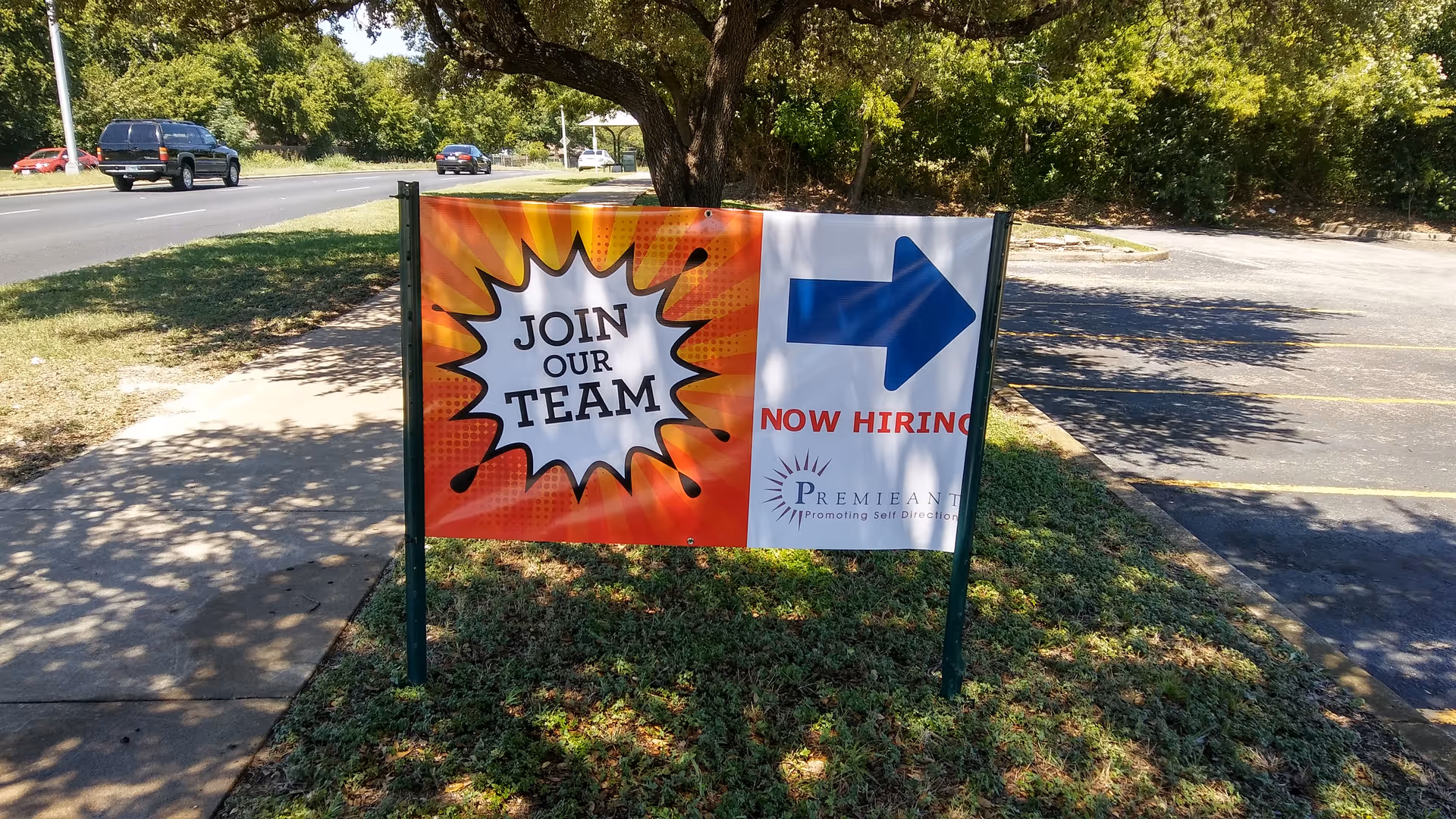 Outdoor recruitment sign on grass promoting Premieant senior living facility.