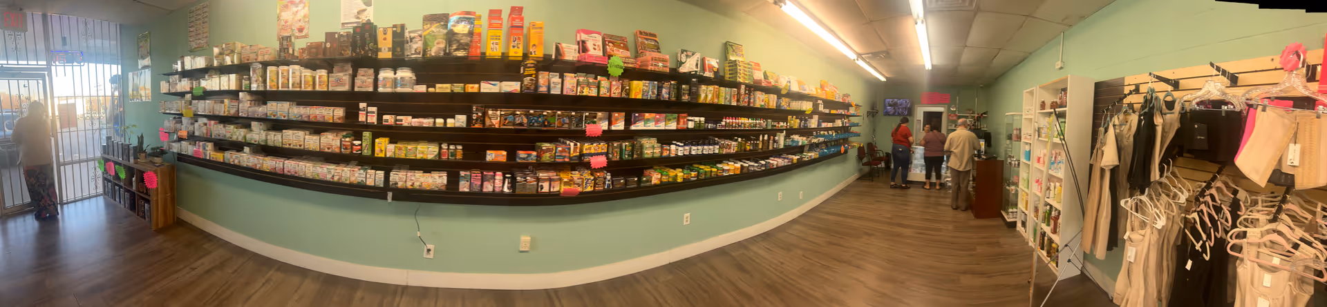 Interior of a senior living facility market with shelves, clothing racks, and customers.