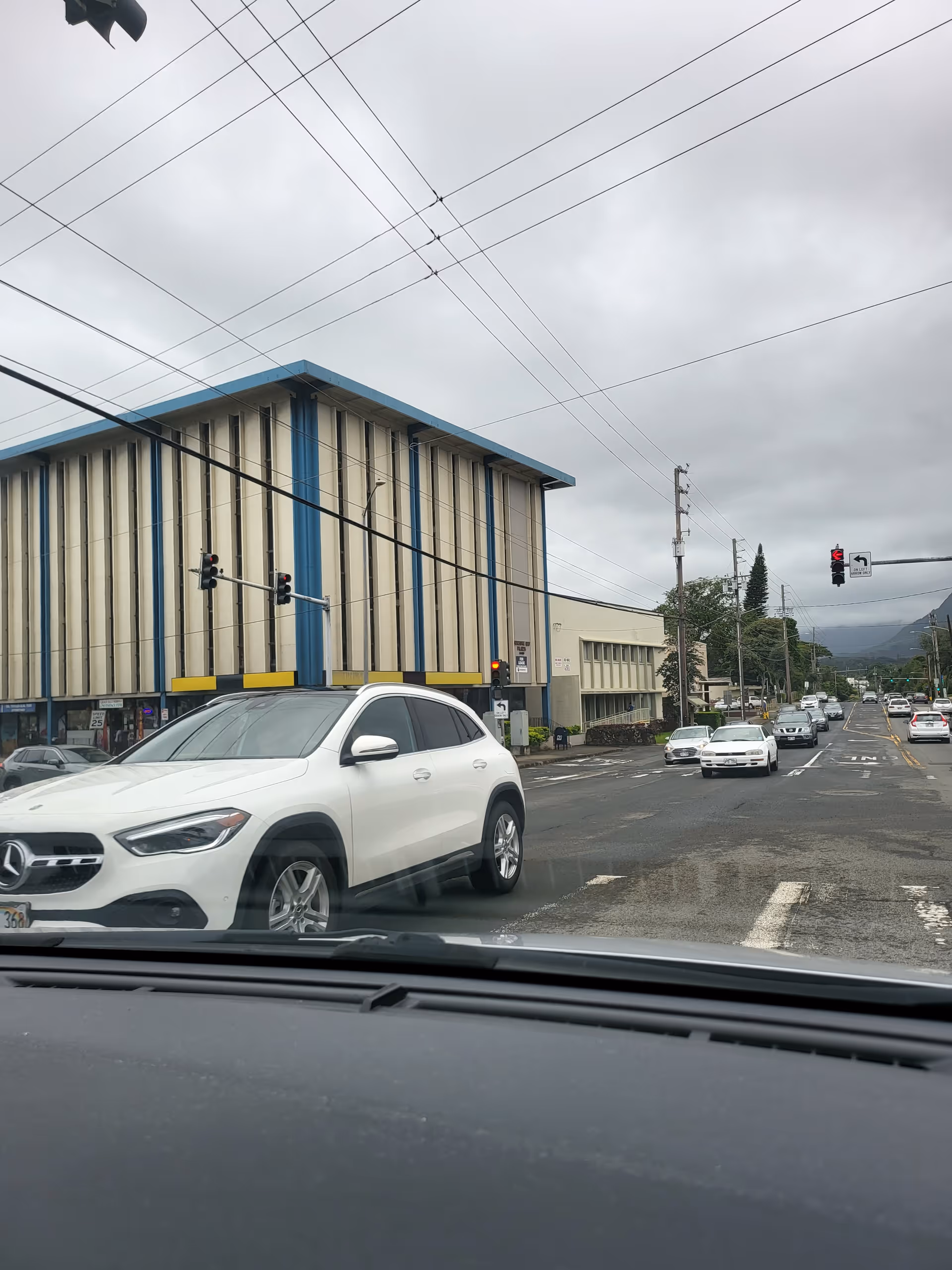 Exterior street view of a blue-trimmed building along a busy road.