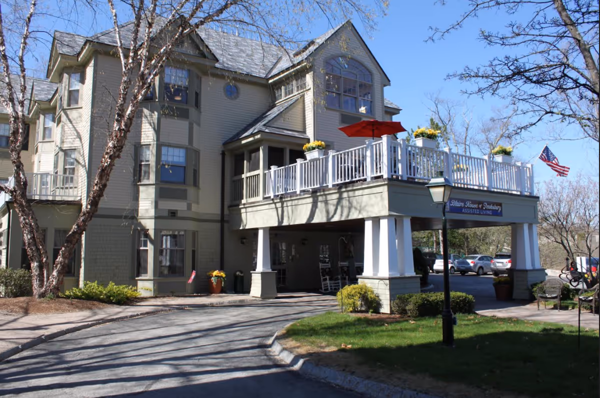Exterior view of Blaire House of Tewksbury with balcony deck, entrance, and flag.