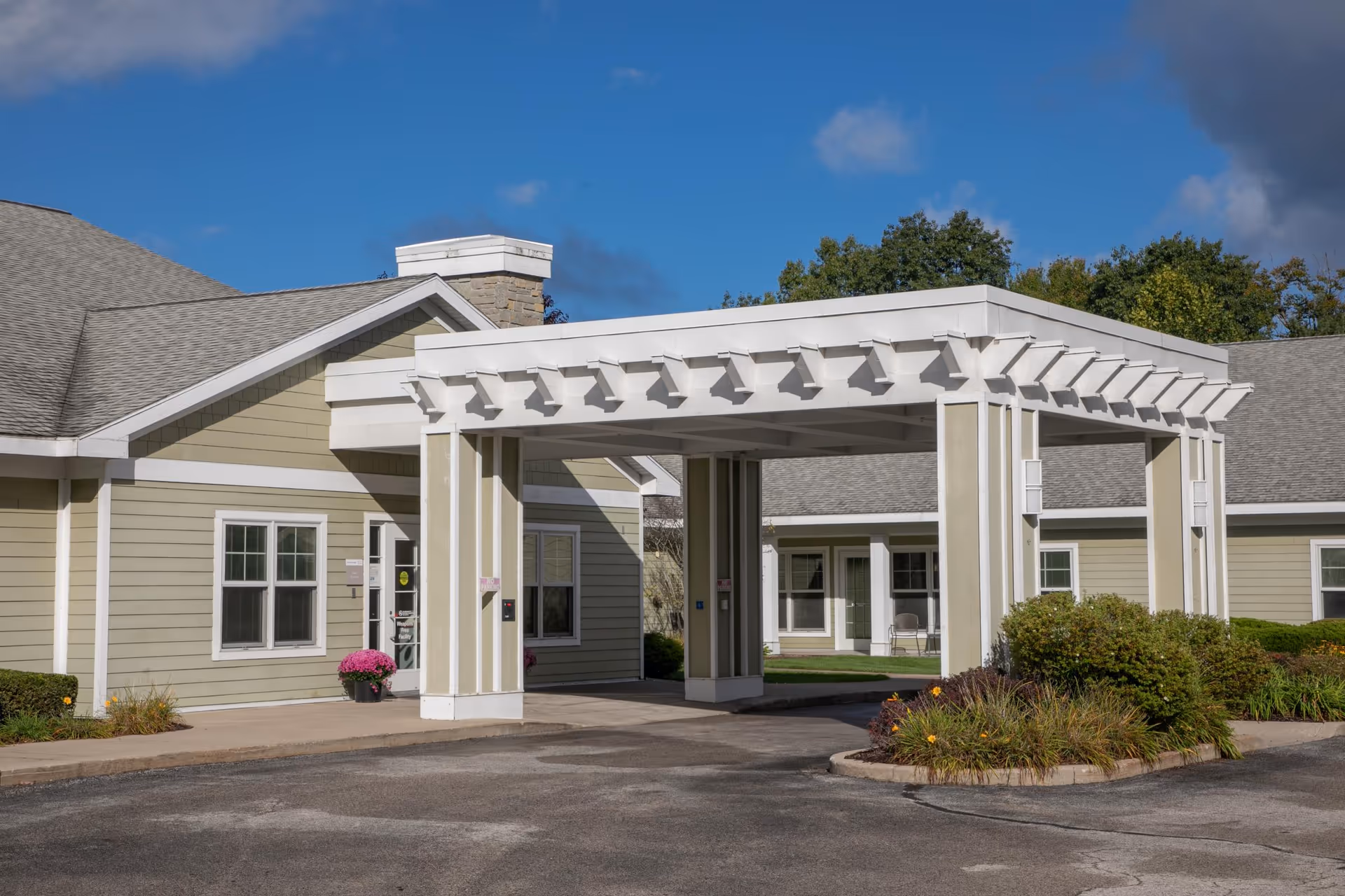 Exterior view of North Ottawa Care Center showing a covered entrance and beige building.