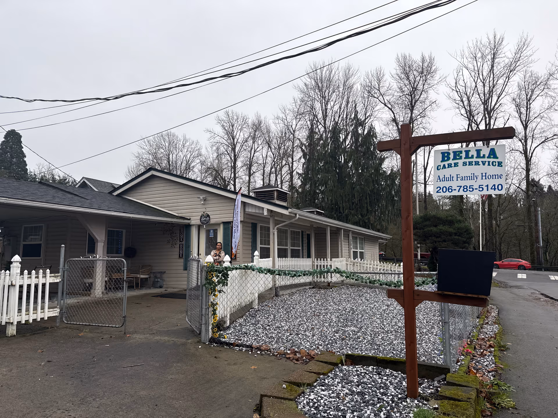 Single-story Bella Care Service Adult Family Home exterior with entrance gate and sign