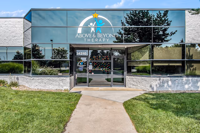 Front exterior of Above and Beyond ABA Therapy Center in Omaha with glass entrance.