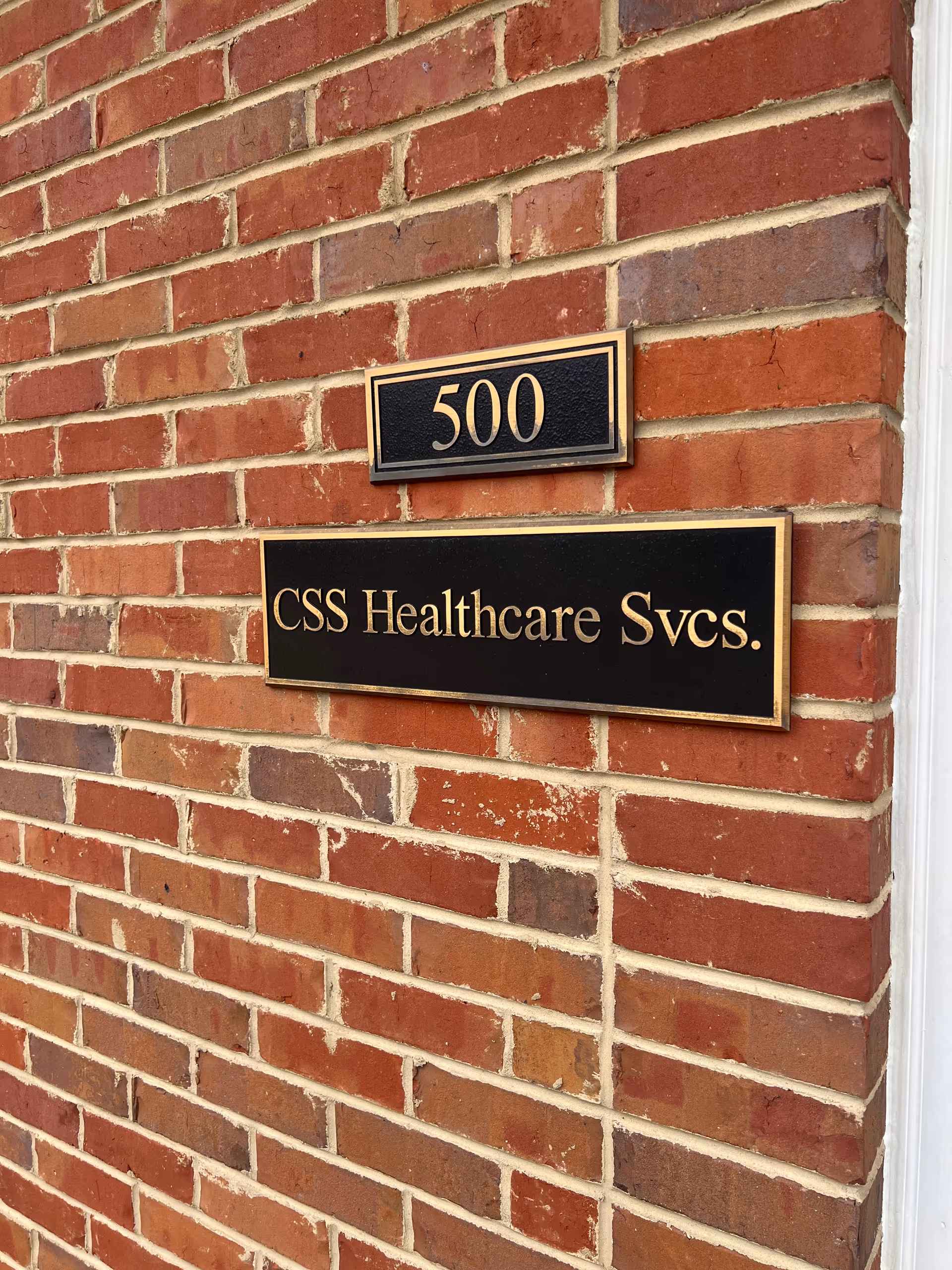 Exterior brick wall with address plaque 500 and CSS Healthcare Svcs sign