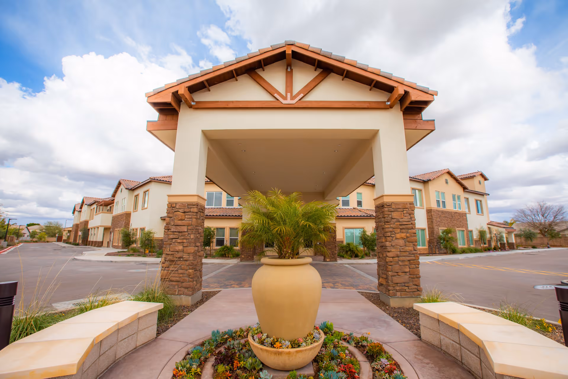 Front entrance of Eternal Spring of Gilbert with a covered entry canopy and a potted plant.