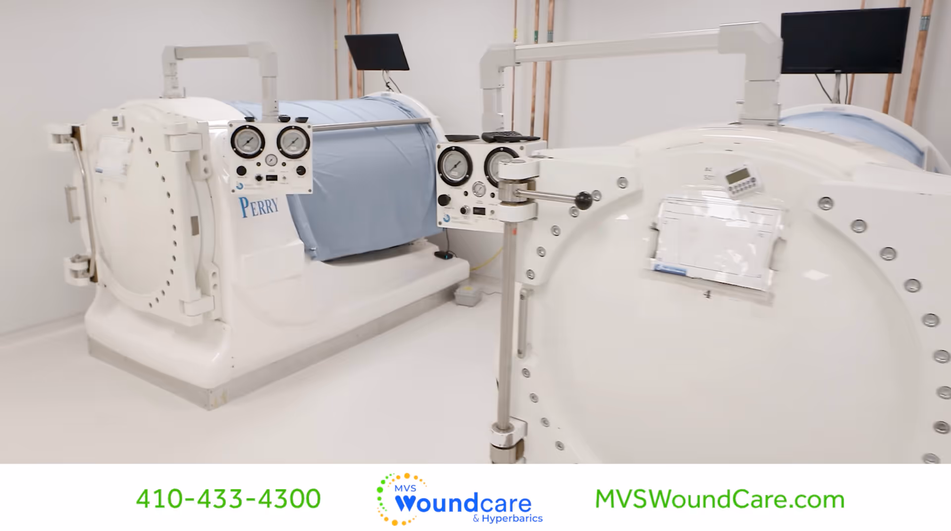 Two white hyperbaric chambers in a clean clinical treatment room.