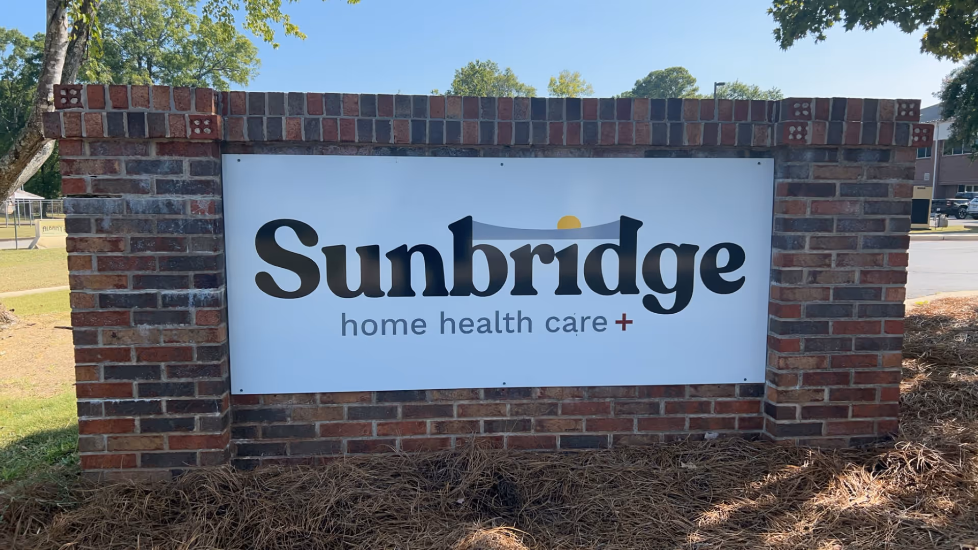 Brick sign reading Sunbridge home health care outside the facility entrance