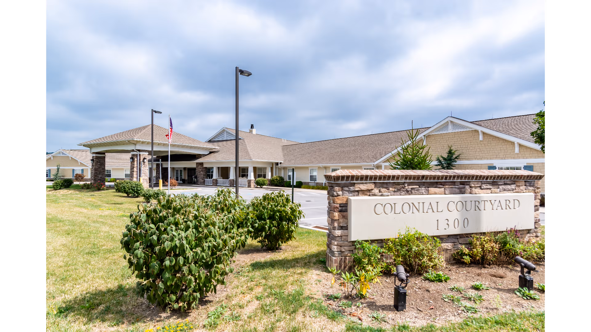 Exterior view of Colonial Courtyard at Clearfield with sign and entry canopy.