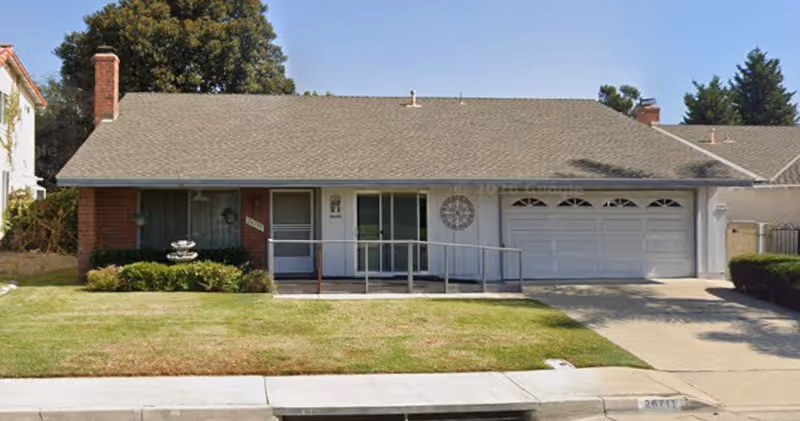 Exterior view of Golden Years Senior Care, a single-story building with ramp, front yard, and garage.