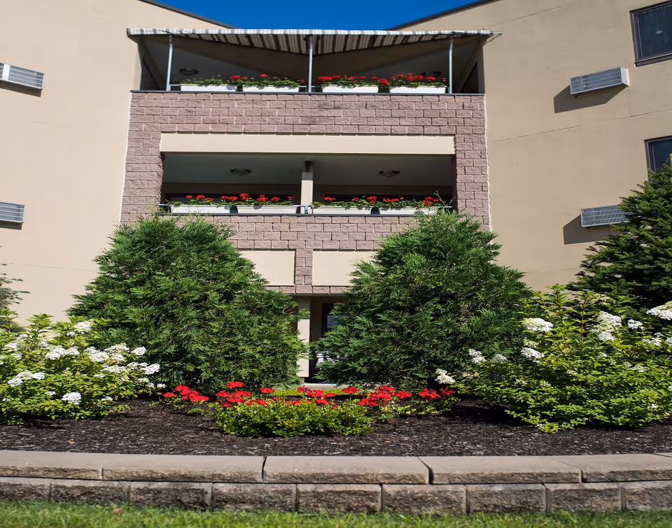 Front view of Beechwood at Eddy Memorial with landscaped flowerbeds and shrubs.