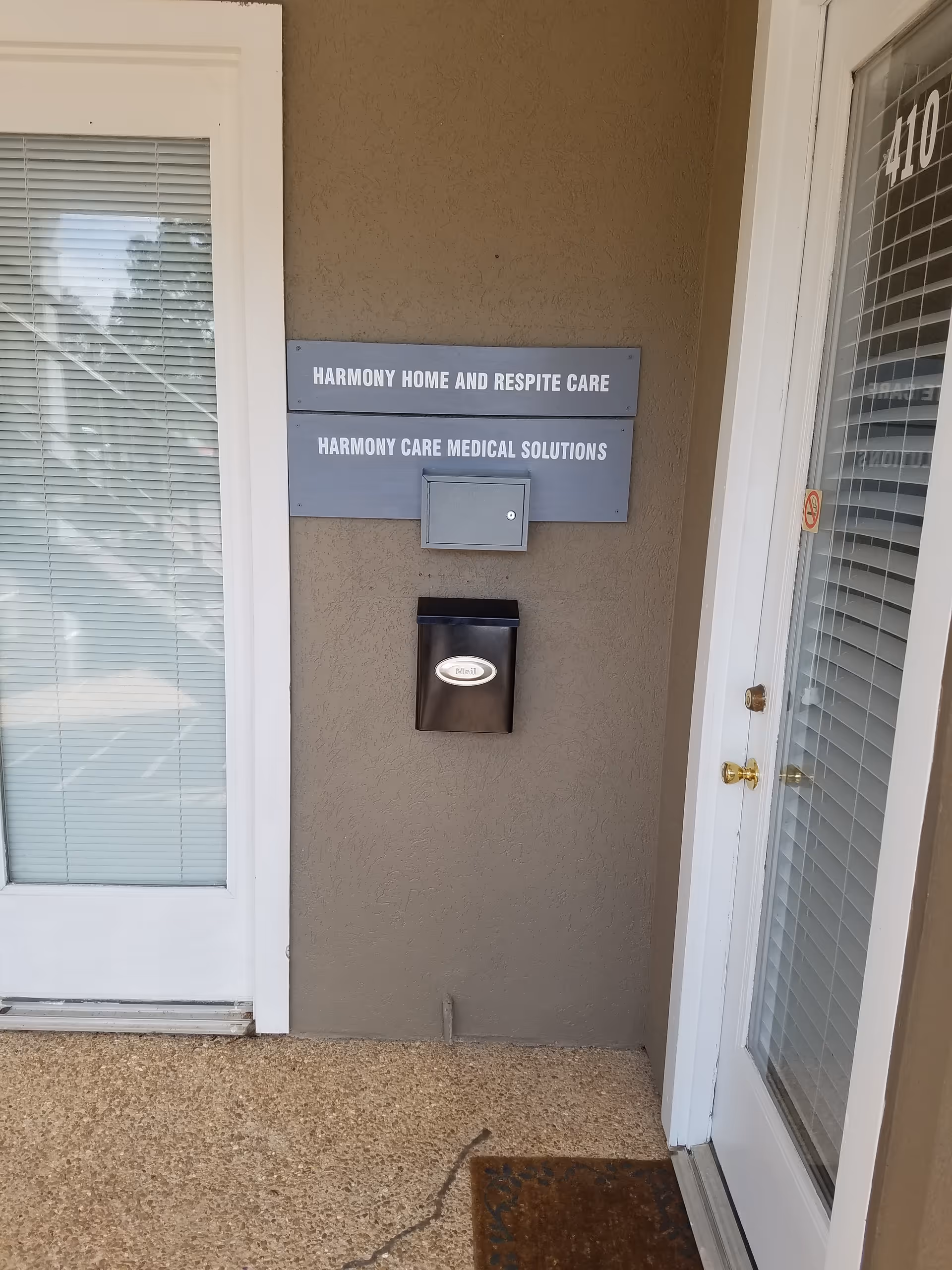 Front exterior of Harmony Home and Respite Care with wall plaques near the entrance.