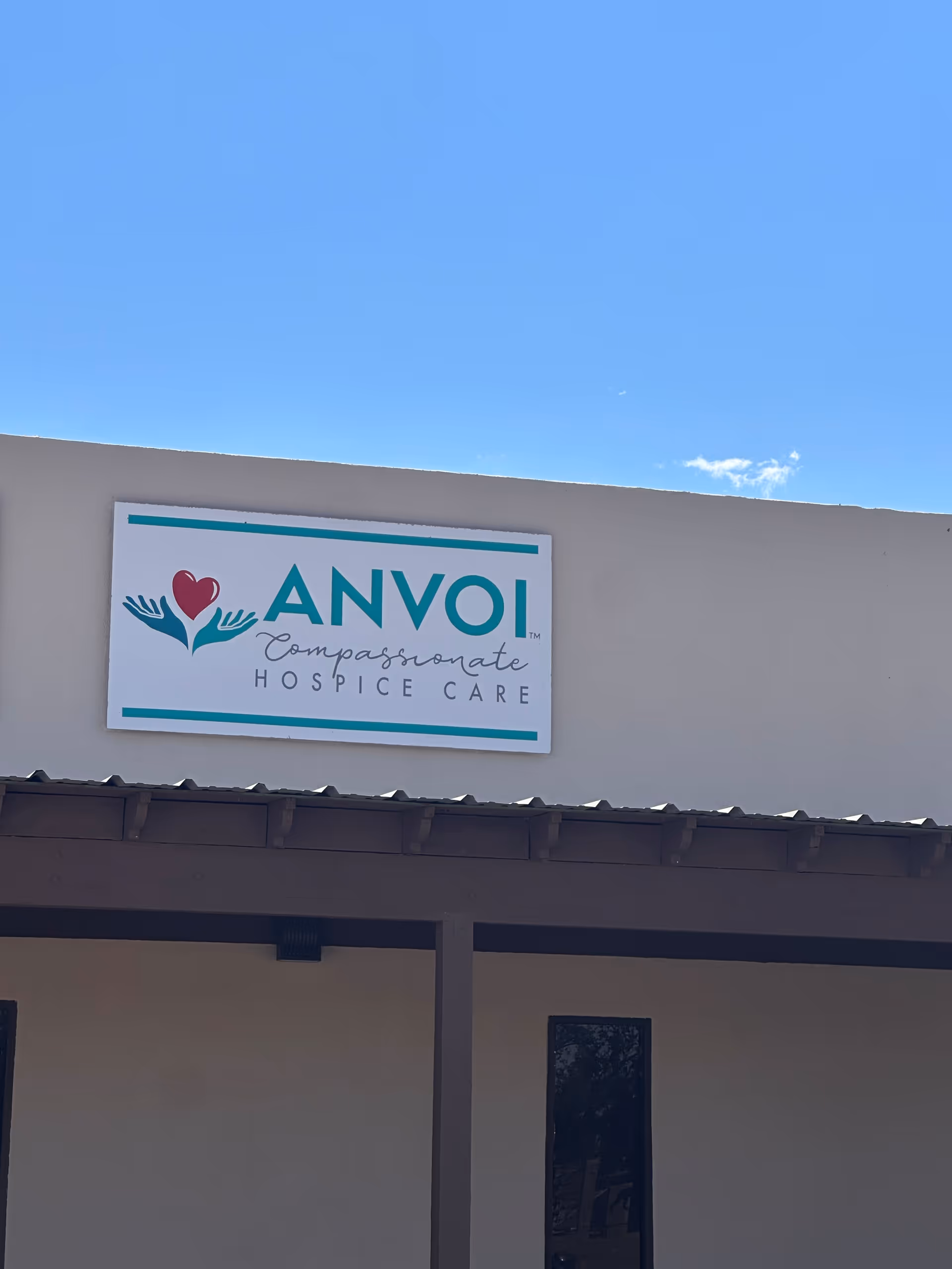 Exterior view of the Anvoi Hospice Care building with a large sign.