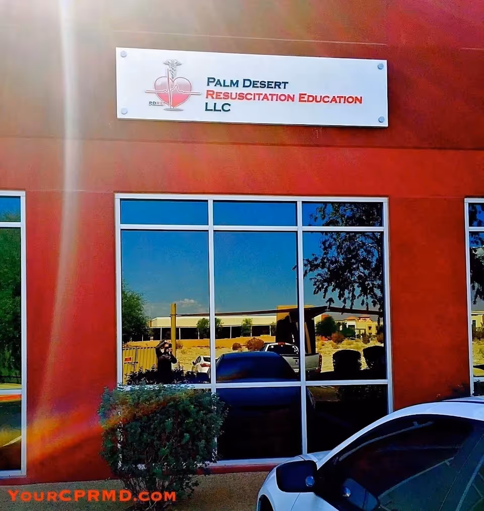 Red building exterior with a Palm Desert Resuscitation Education sign on the front.