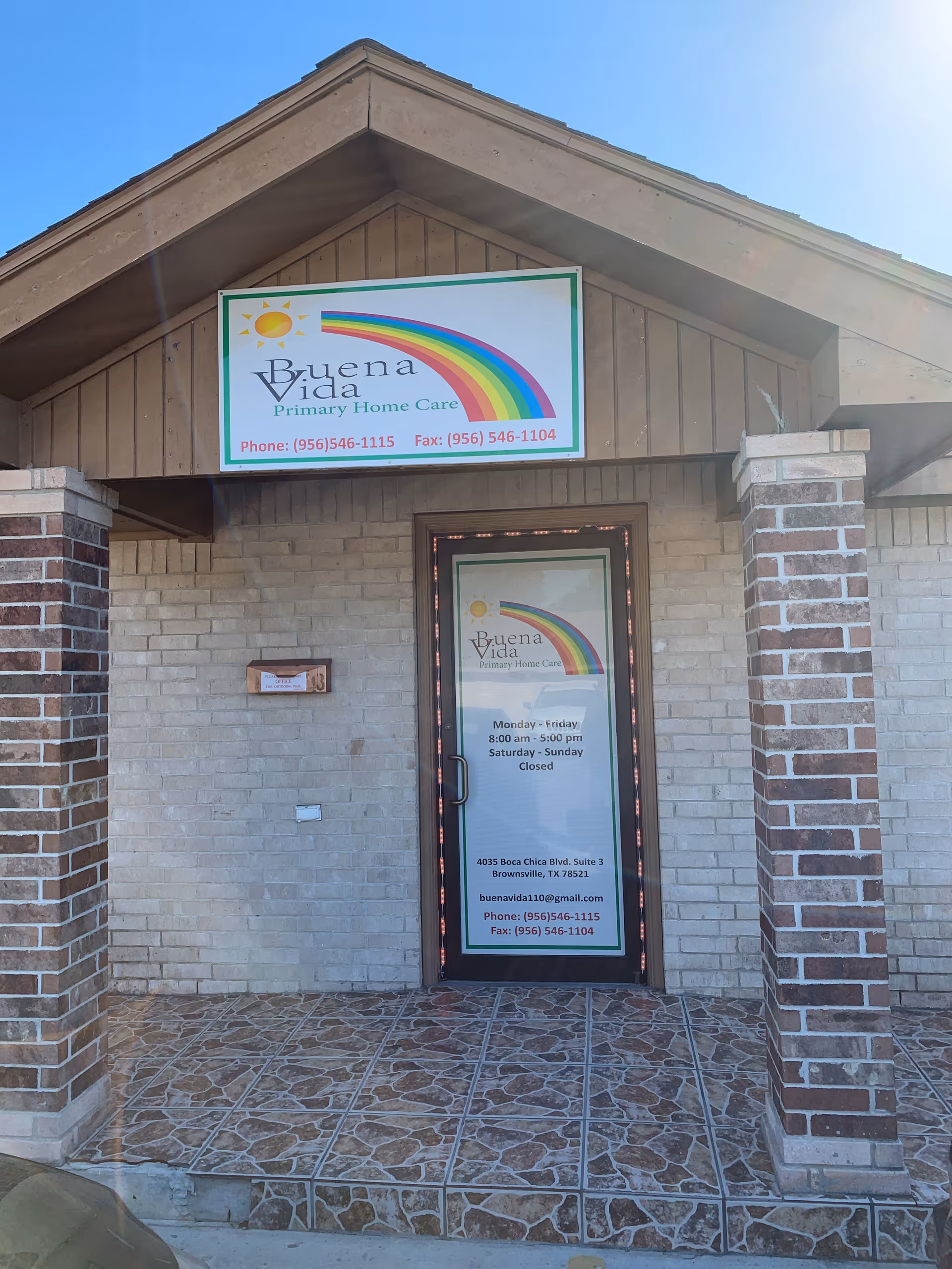 Front entrance of Buena Vida Primary Home Care with sign and rainbow logo.