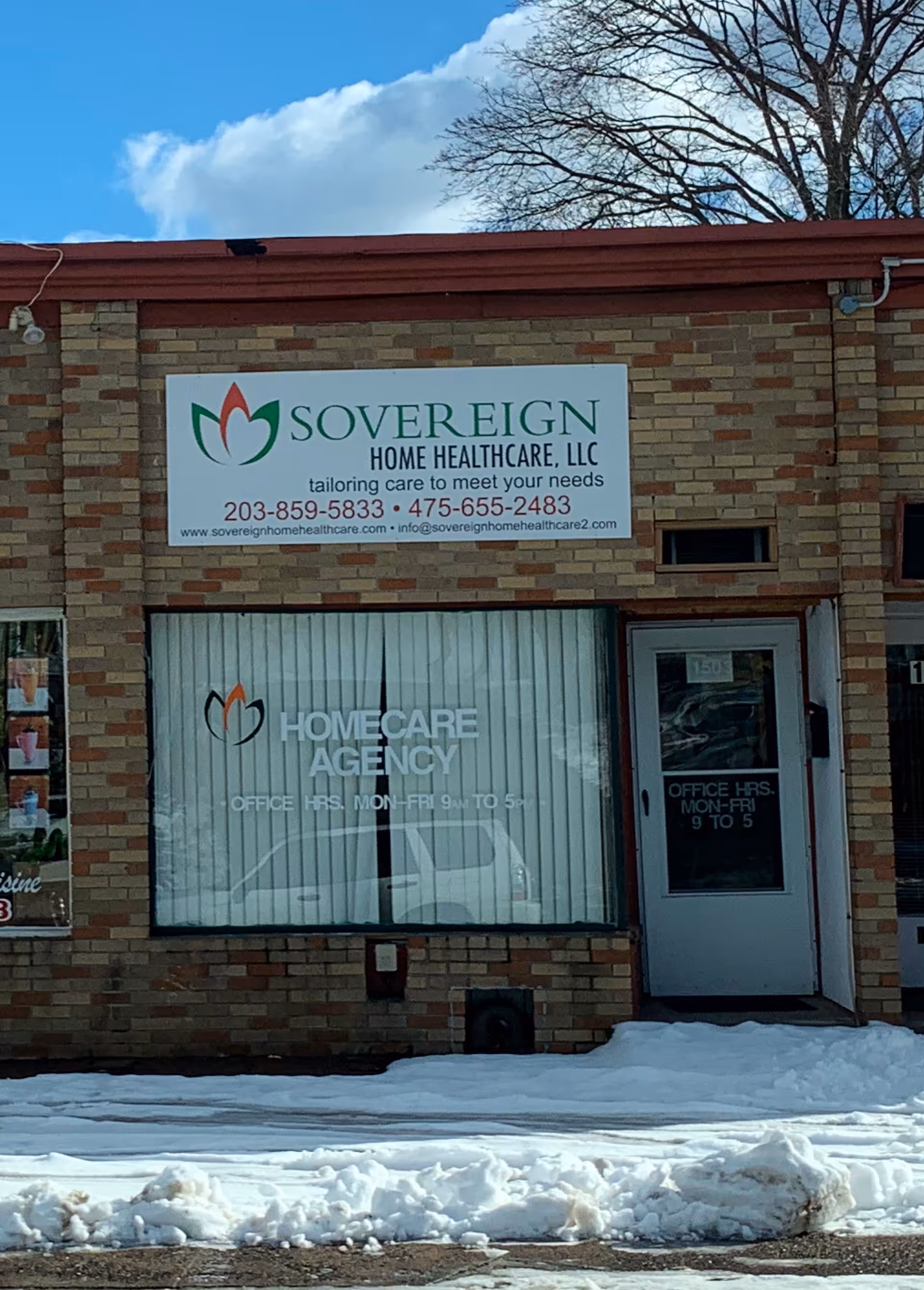 Brick building exterior with Sovereign Home Healthcare sign and a large office window.