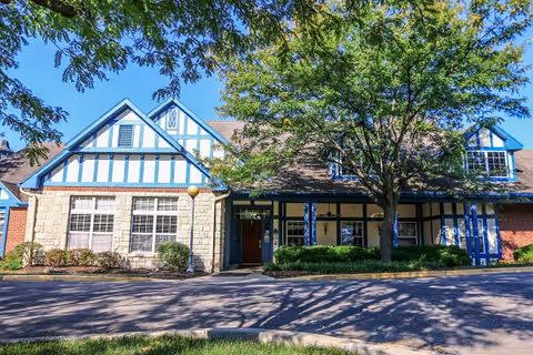 Exterior view of Vintage Park at Lenexa entrance with blue trim and trees.