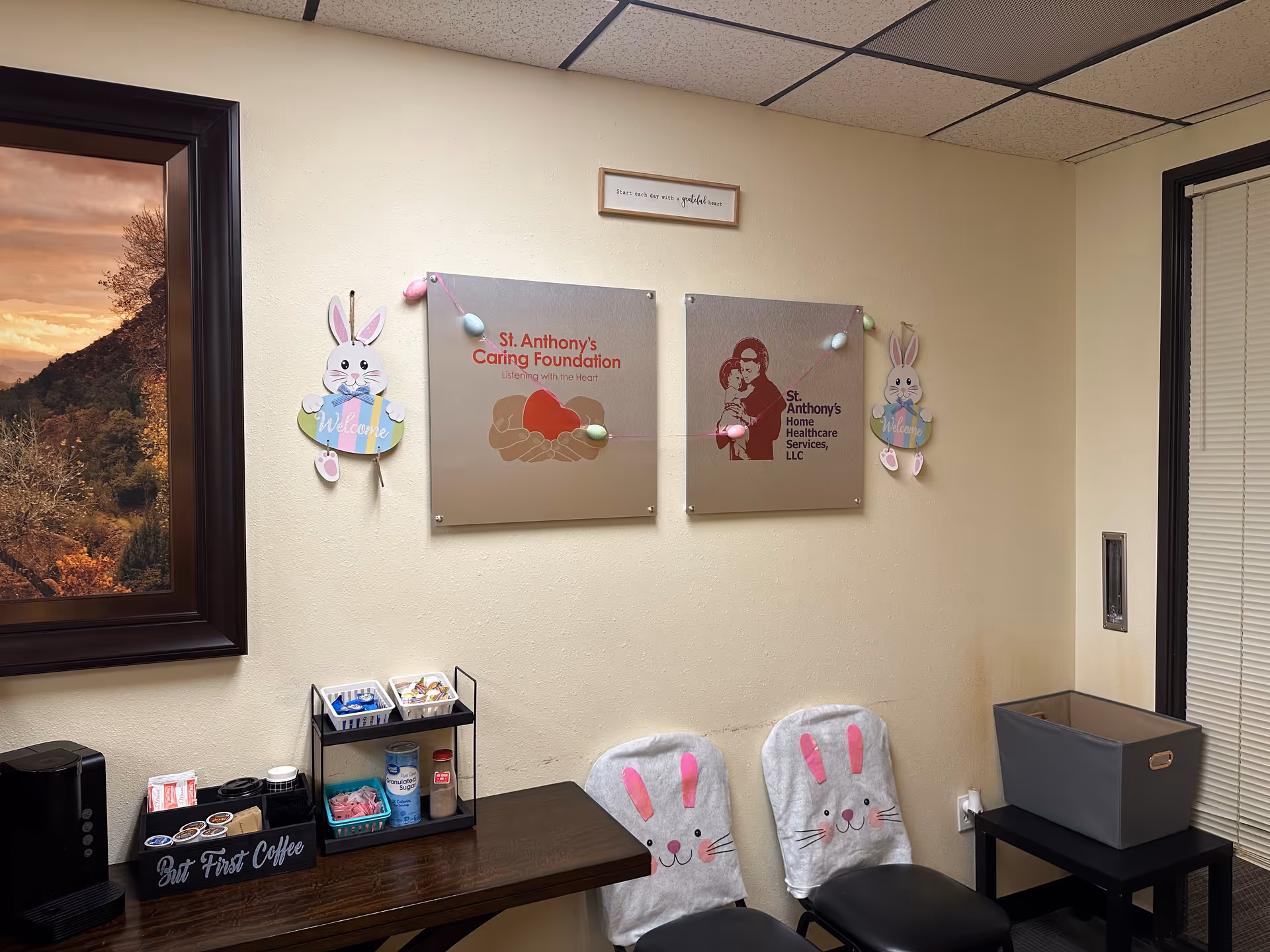 Cozy lobby with wall plaques, bunny decor, a coffee station, and bunny-covered chairs.