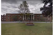 Brick Bradford Hills Nursing and Rehabilitation Center exterior with entrance, lawn, and circular planter.